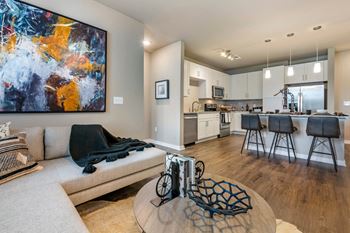 A modern living room with a large abstract painting on the wall at JTB Apartments, Jacksonville, FL, 32256