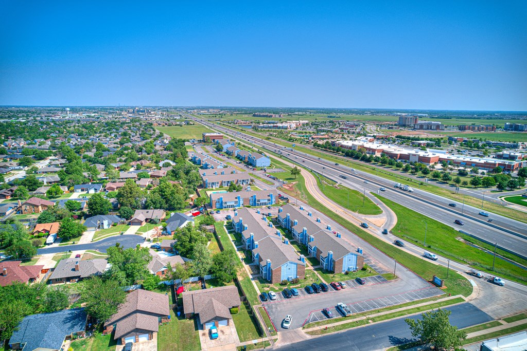 aerial view of blue building and sky and green grass