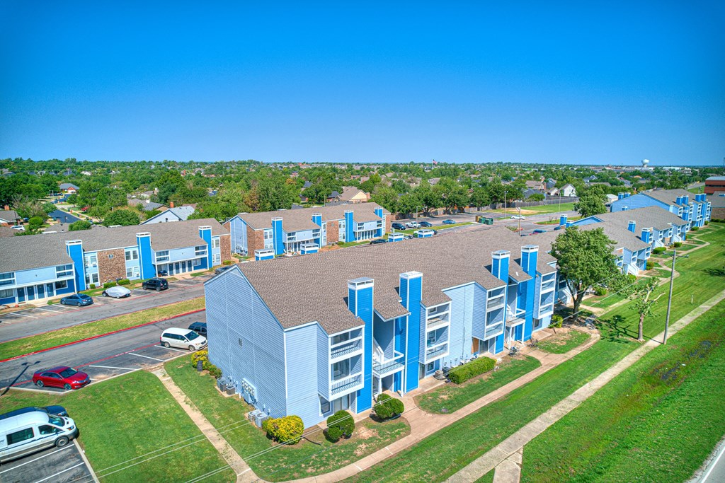 aerial view of blue building and sky and green grass