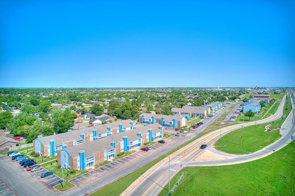 aerial view of blue building and sky and green grass