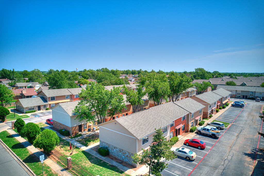 an aerial view of a neighborhood of houses with cars parked