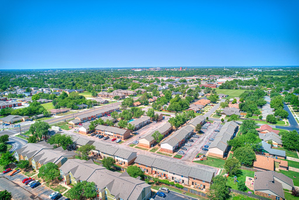 an aerial view of a neighborhood of houses and cars in a parking lot
