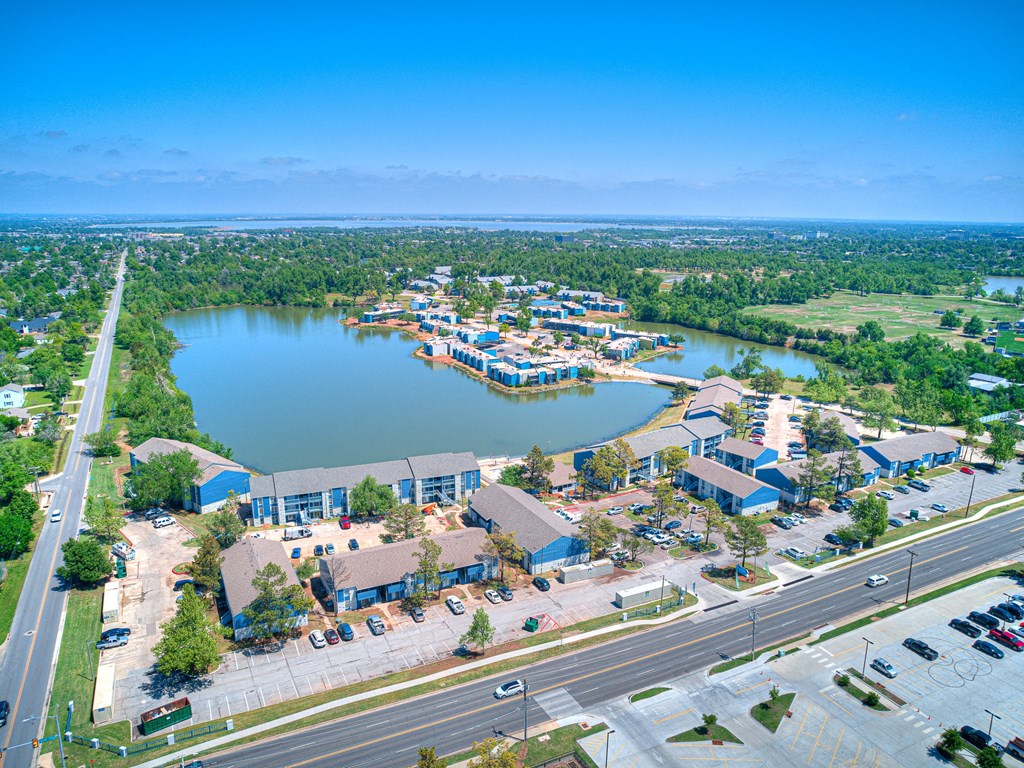 an aerial view of a city with a lake and a highway