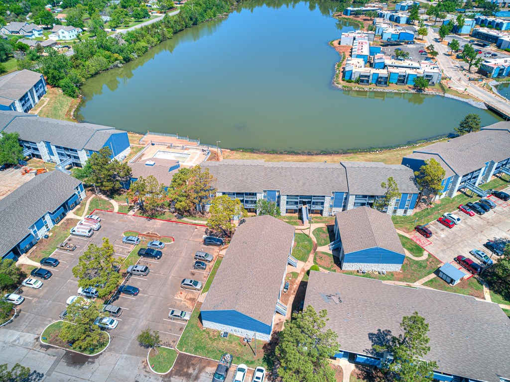 an aerial view of a group of buildings and a lake