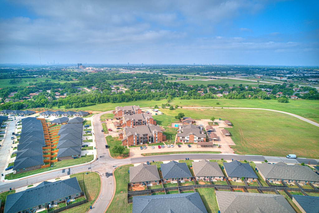 an aerial view of a city with houses and a field