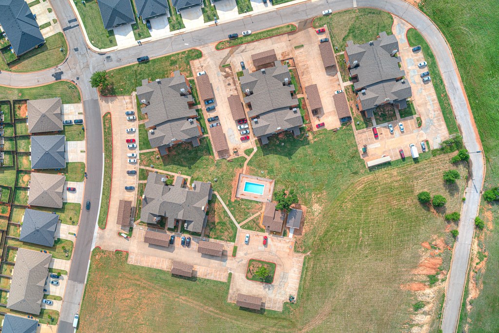 arial view of a neighborhood with houses and a pool