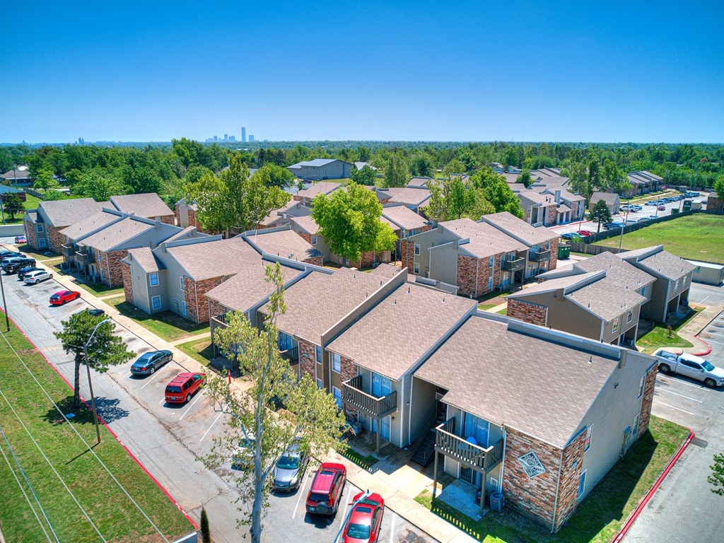 an aerial view of a row of houses with cars parked in a parking lot at Diamond  Trail Apartments, Oklahoma City, 73112