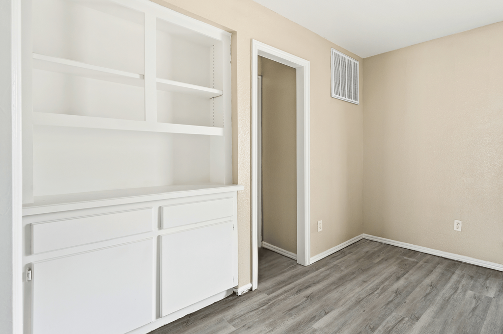 an empty room with white shelves and a door to a closet at Diamond Ridge Townhomes, Oklahoma City Oklahoma