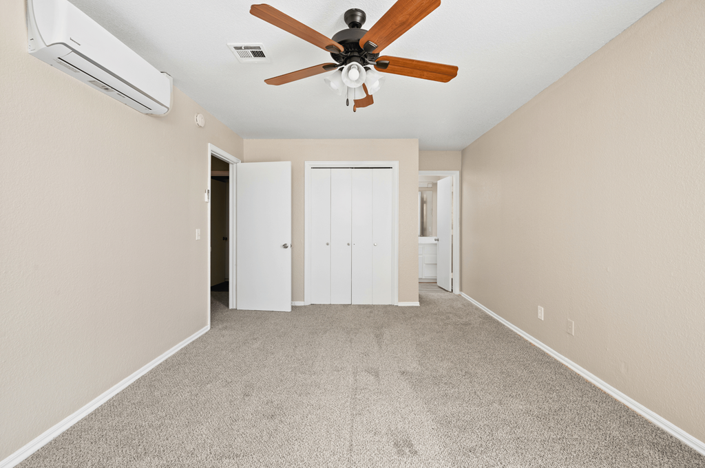 an empty living room with a ceiling fan and carpet at Diamond Ridge Townhomes, Oklahoma City, OK