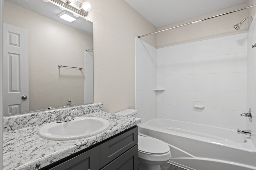 the preserve at ballantyne commons apartment bathroom with tub and sink and toilet at Diamond Ridge Townhomes, Oklahoma City