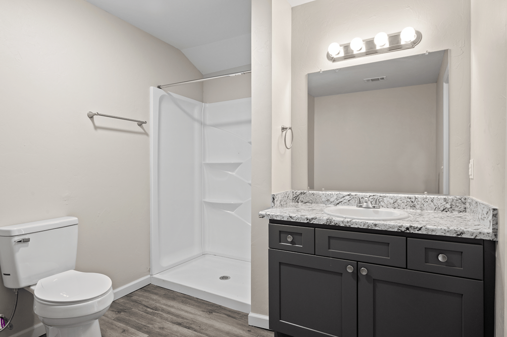 a bathroom with a toilet sink and shower and a mirror at Diamond Ridge Townhomes, Oklahoma City, 73114