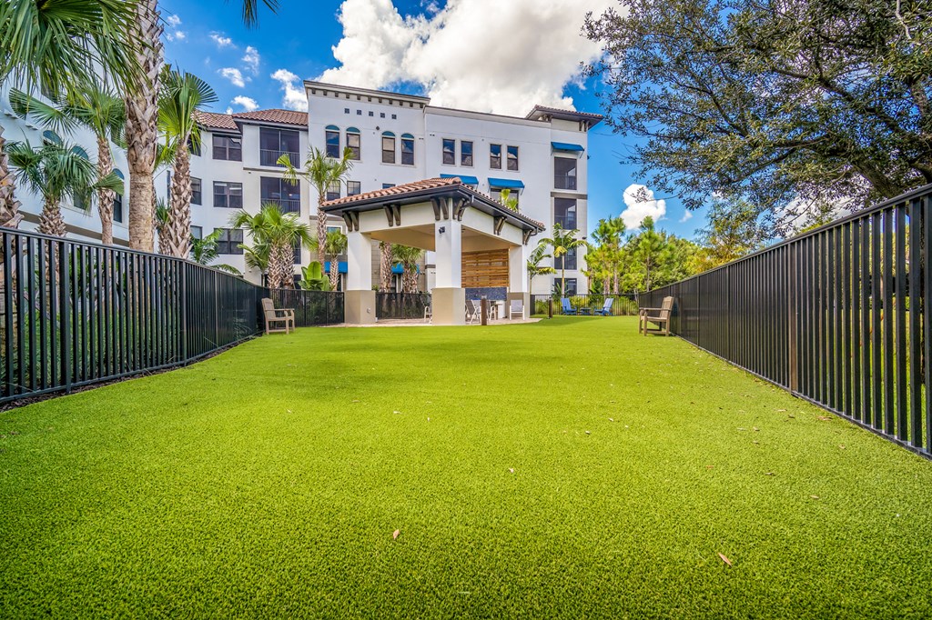 green lawn enclosed by black fence at Magnolia Square, Naples, FL