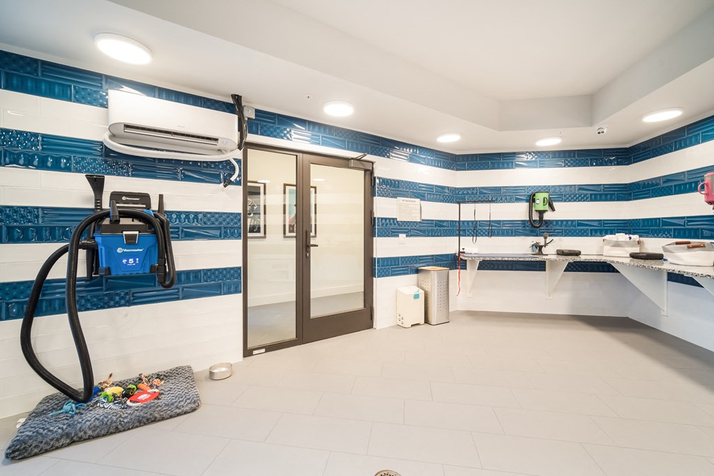 a pat spa with a shower and sinks and a blue and white striped wallpaper at Magnolia Square, Florida, 34109