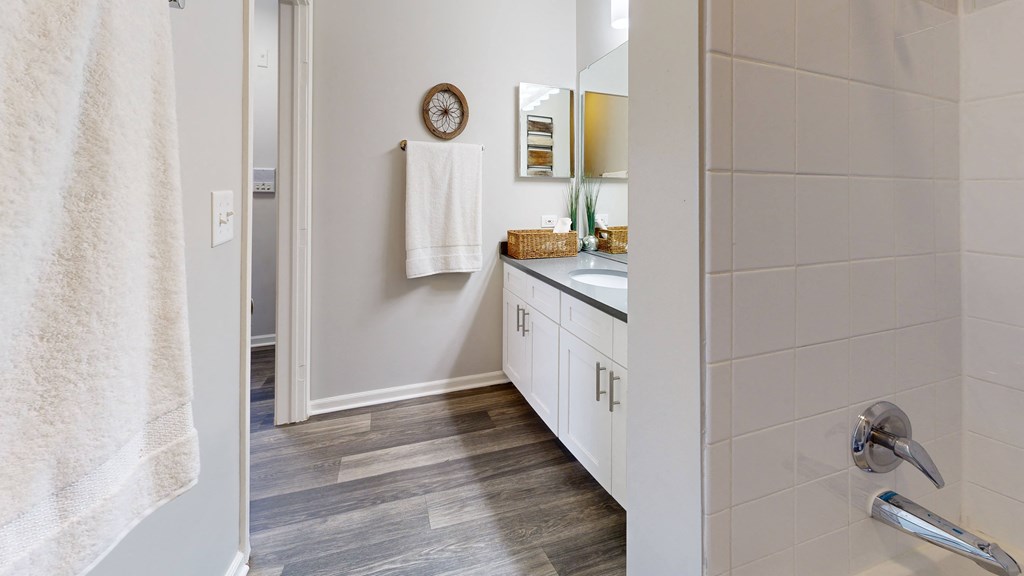 a bathroom with a shower and a sink and a mirror at Dwell at Naperville, Naperville, 60563