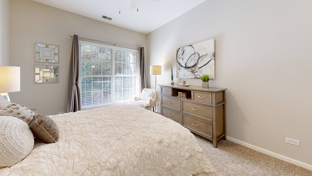 a bedroom with a large bed and a window at Dwell at Naperville, Naperville, Illinois