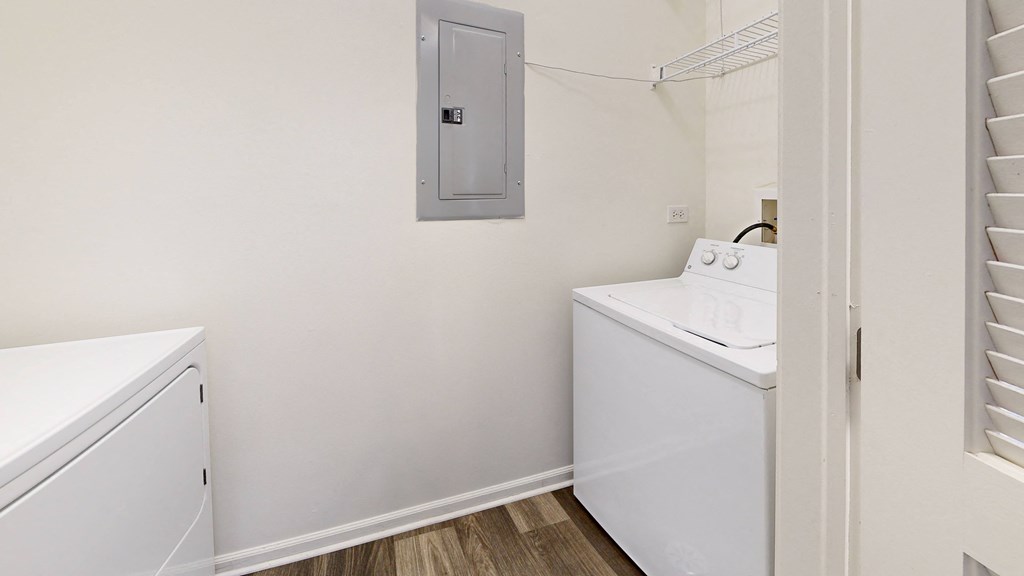 a small laundry room with a washer and dryer and a laundry room door at Dwell at Naperville, Naperville, Illinois