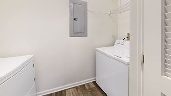 a small laundry room with a washer and dryer and a laundry room door