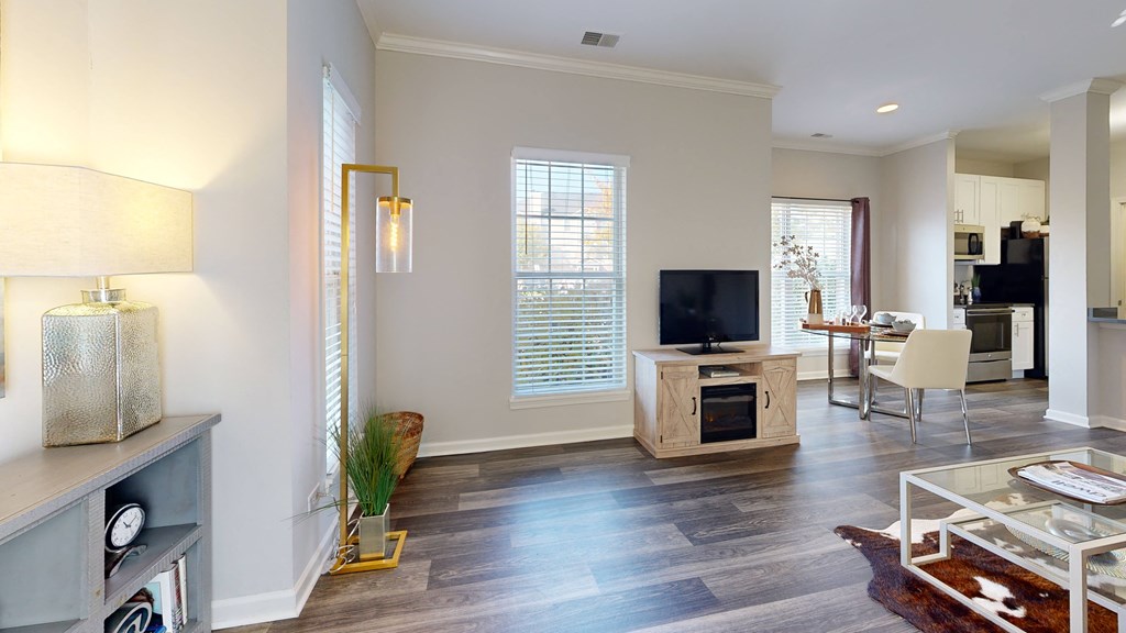 a living room with a tv and a dining room at Dwell at Naperville, Naperville, IL, 60563