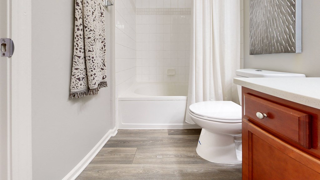 a bathroom with a toilet and a tub and a sink at Dwell at Naperville, Illinois