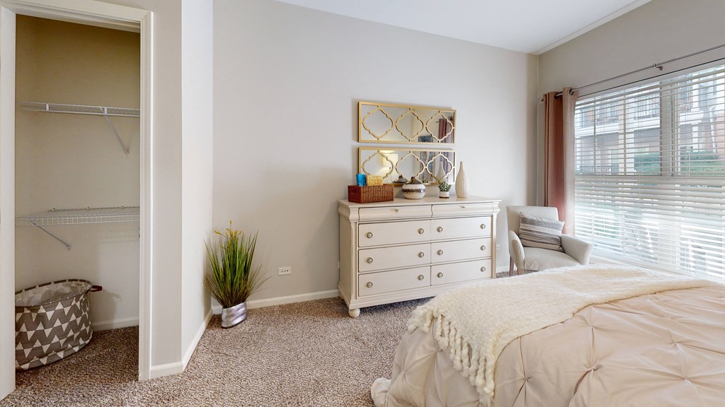 a bedroom with a bed and a dresser at Dwell at Naperville, Naperville