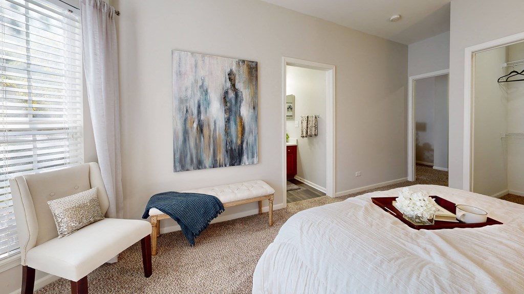 a bedroom with a bed and a painting on the wall at Dwell at Naperville, Naperville, 60563