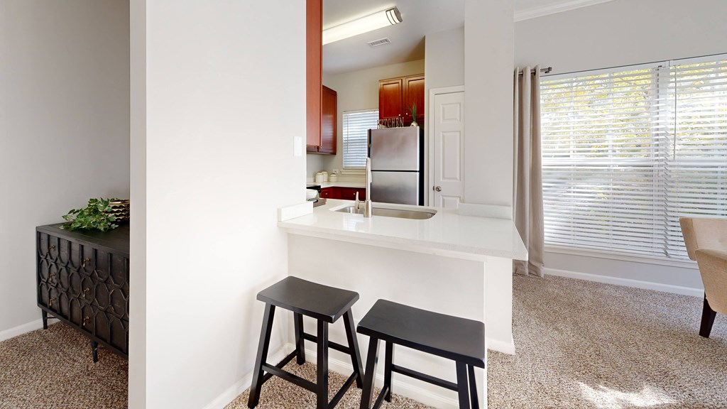a kitchen with a counter and two stools at Dwell at Naperville, Naperville, 60563