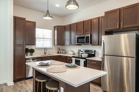 an updated kitchen with stainless steel appliances and a white counter top