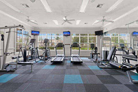 a large fitness room with treadmills and other exercise equipment at The Haven at Commons Park Apartment , Chattanooga, TN