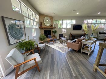 a living room with couches chairs and a fireplace