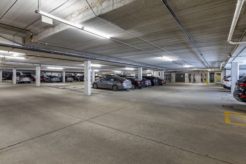 the parking garage is filled with parked cars