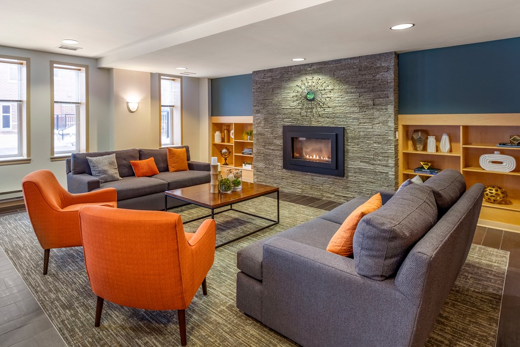 a living room with couches and chairs and a fireplace