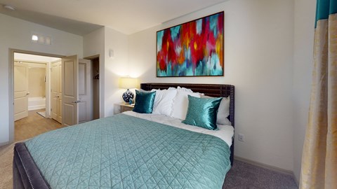a bedroom with a large bed and a colorful painting on the wall at Integra 360 Apartments, Florida, 32708