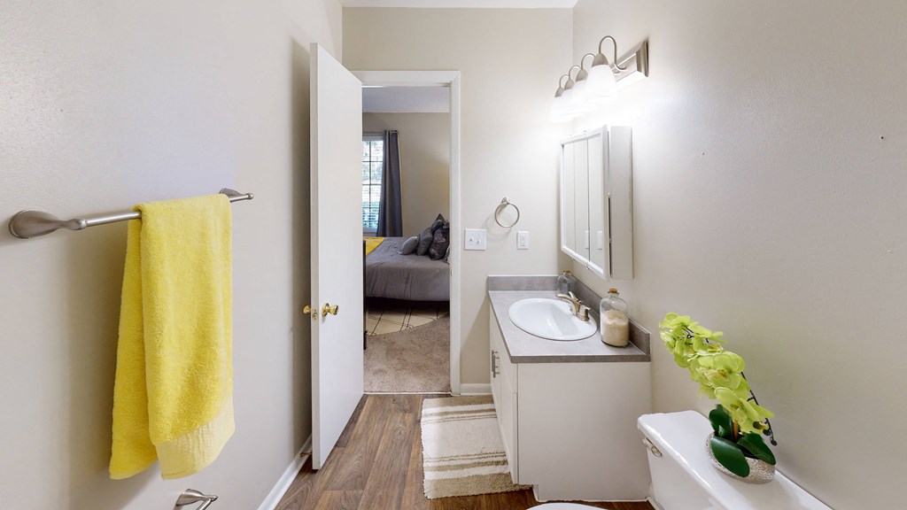 a bathroom with a white sink and a yellow towel at Laurel Oaks Apartments, Tampa, FL, 33637