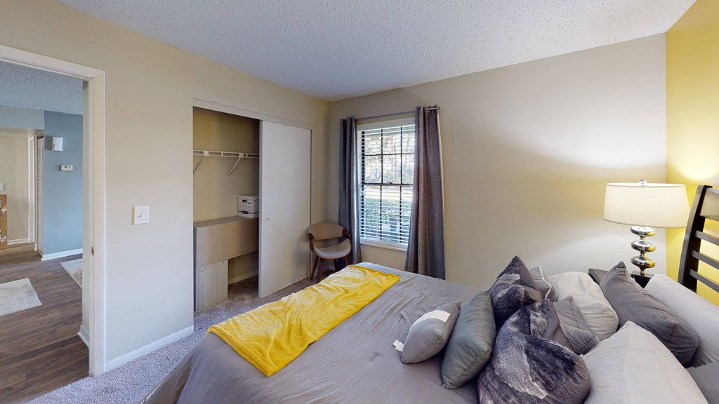 a bedroom with a large bed and a desk in a room at Laurel Oaks Apartments, Florida