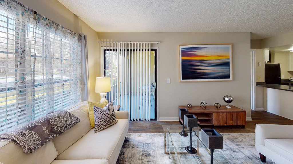 a living room filled with furniture and a large window at Laurel Oaks Apartments, Tampa, FL