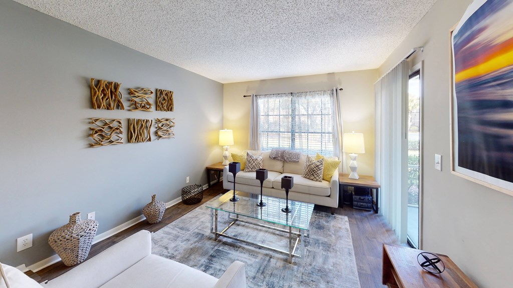 a living room with white couches and a glass coffee table at Laurel Oaks Apartments, Florida, 33637