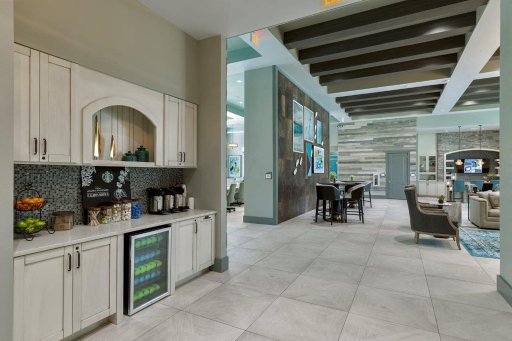 a kitchen with white cabinets and a table with chairs