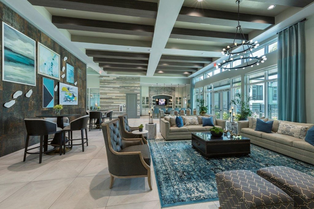 a large living room with couches and chairs and a table