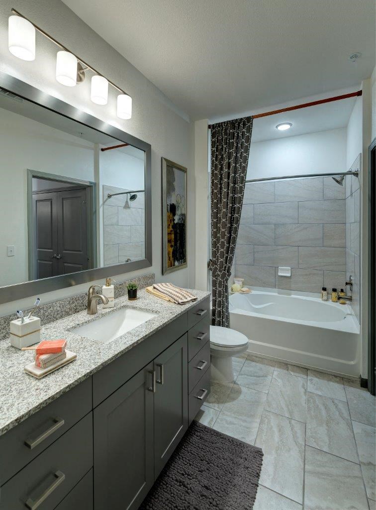 a bathroom with a sink and a shower and a toilet