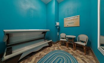 A room with blue walls and a white bench at The Addison on Long Bayou Apartments, Seminole, 33772