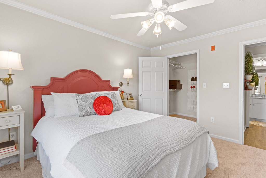 a bedroom with a bed and a ceiling fan