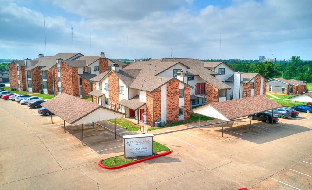 an aerial view of a row of houses in a parking lot