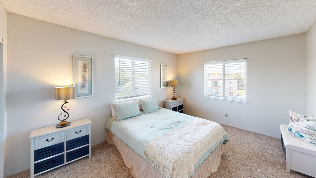 a bedroom with a bed and two night stands