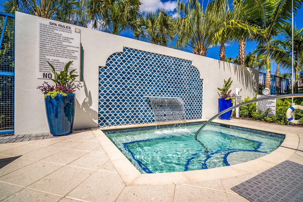 small pool  surrounded by blue mosaic tiles on wall at Magnolia Square, Naples, Florida