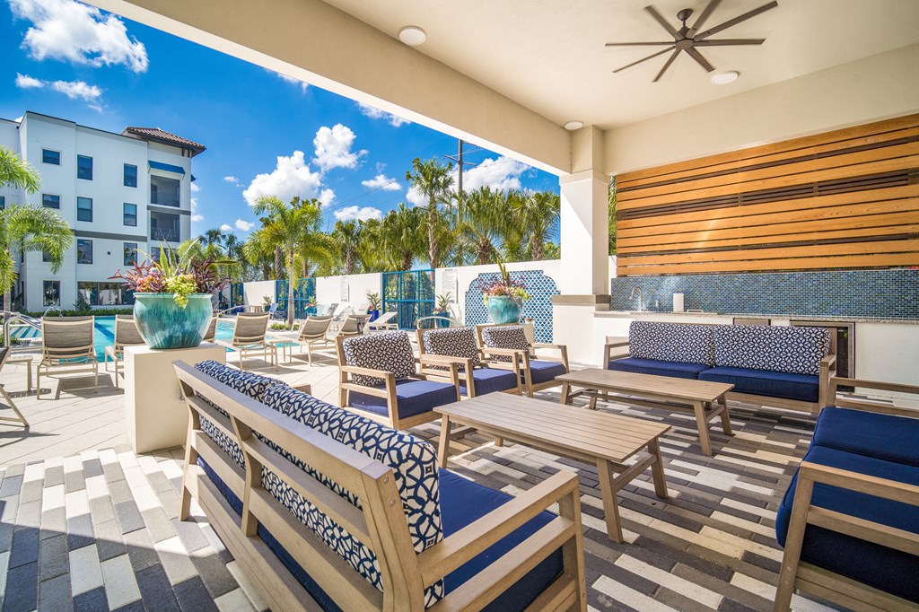 a patio with tables and chairs at the resort at longboat key club at Magnolia Square, Florida
