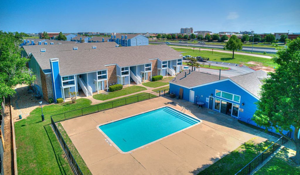an aerial view of a building with a swimming pool