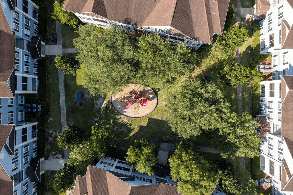 a birdseye view of a park with people sitting on the grass at Magnolia Village Apartments, Jacksonville, FL, 32207