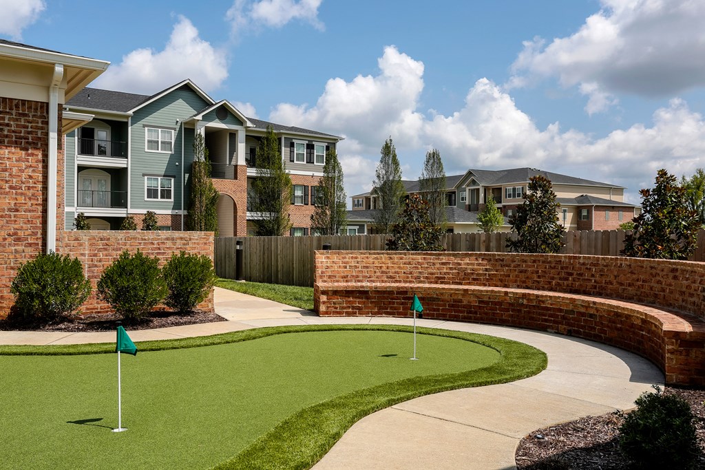 an image of an apartment building with a golf course in front of it at Annandale Apartment Homes, Murfreesboro, TN