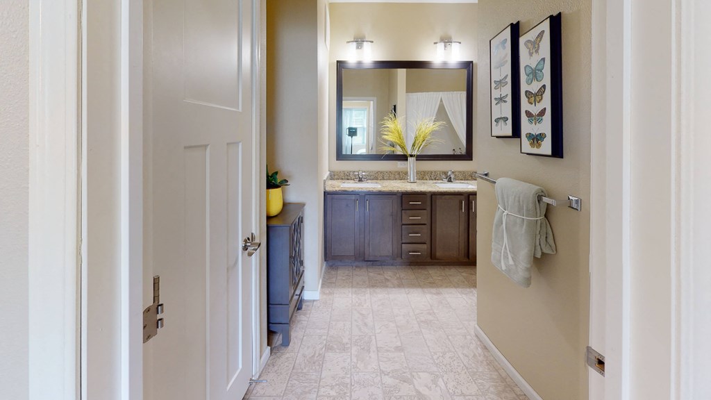 a bathroom with a sink and a mirror at Skye at Arbor Lakes, Minnesota