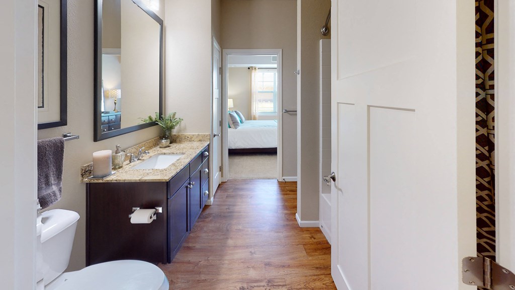 a bathroom with a toilet sink and mirror at Skye at Arbor Lakes, Maple Grove, 55369